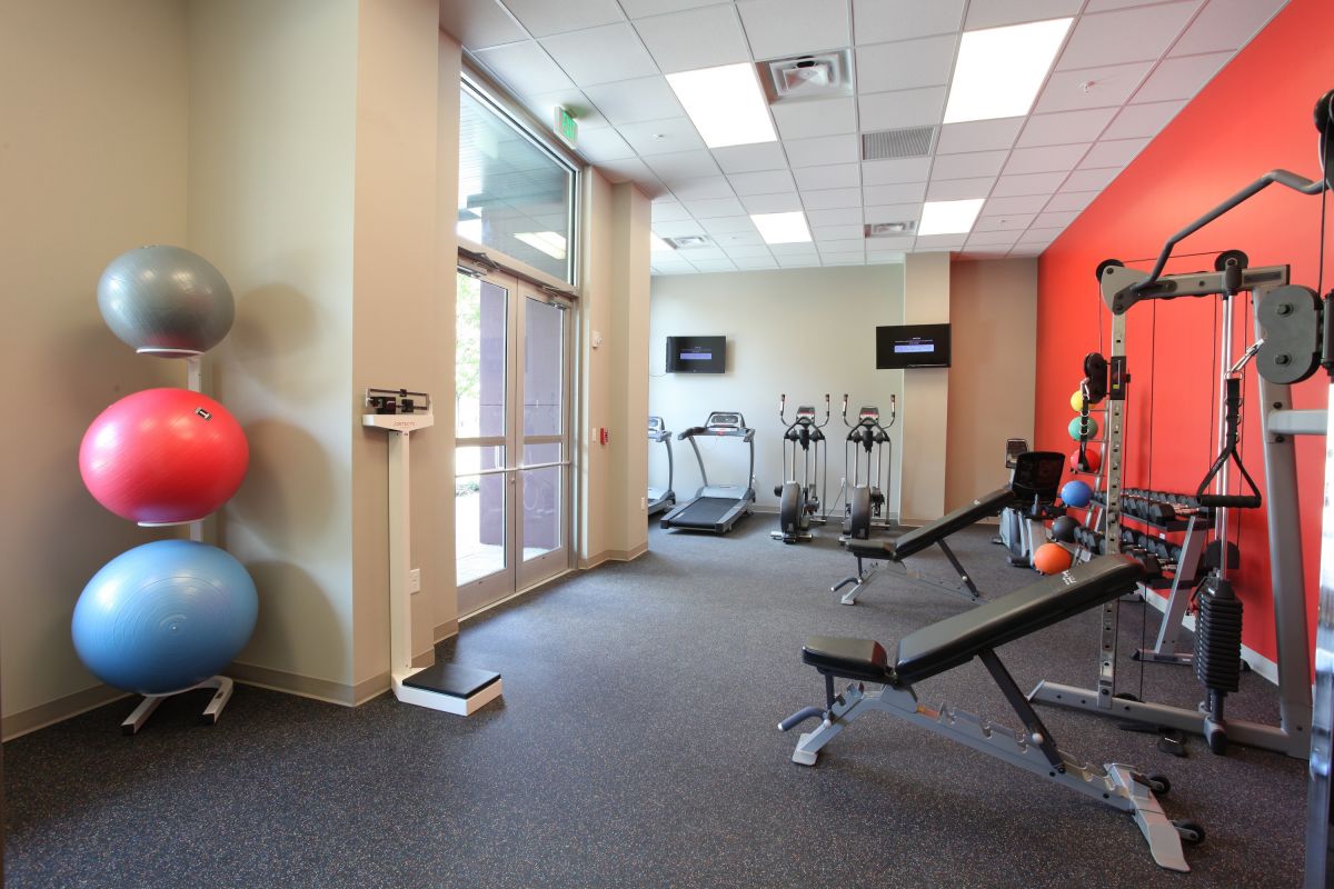 Fitness room with various equipment.