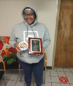 A woman holding an award.