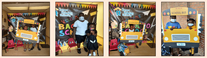 Various children holding a cardboard school bus.