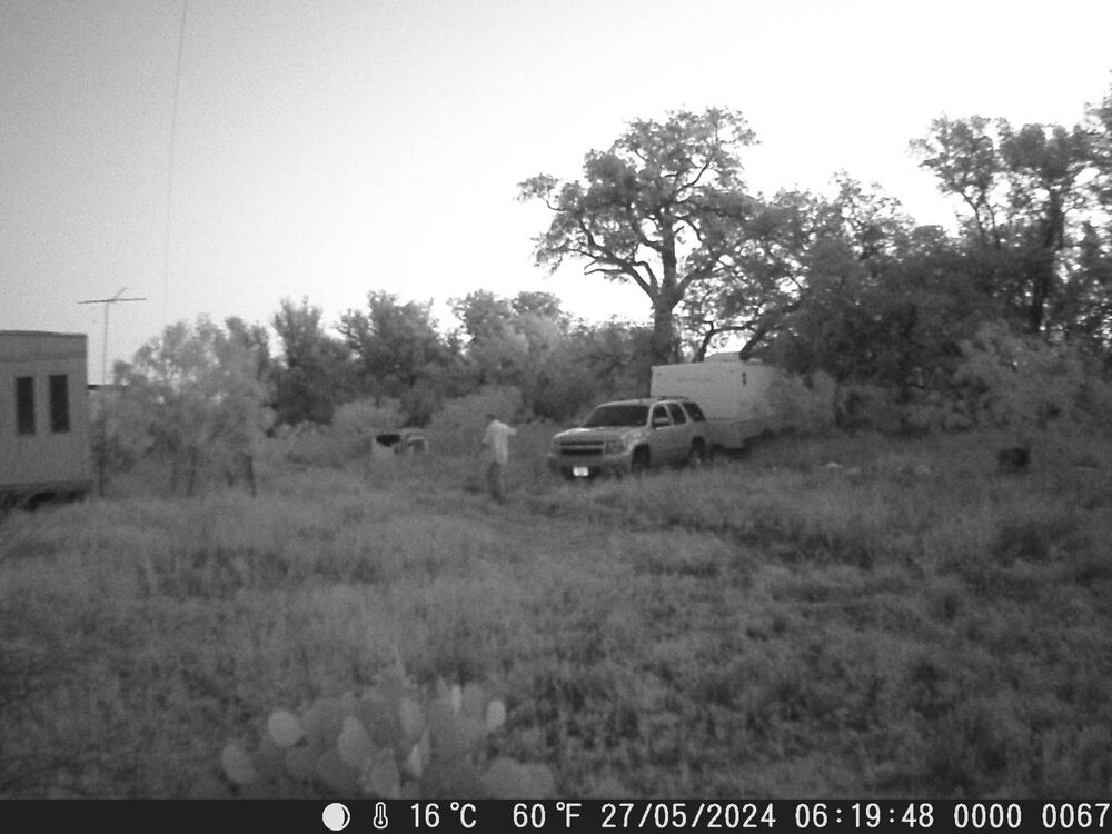 Suspect next to a camper trailer.