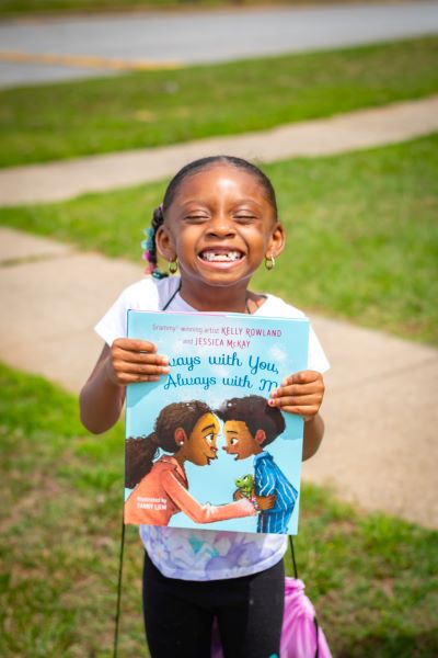 Girl smiling with her new book. 