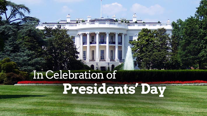 In Celebration of Presidents' Day with the White House surrounded by trees and bushes in the background.