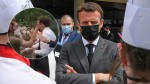 Macron was slapped in the face and the two men were arrested by the police