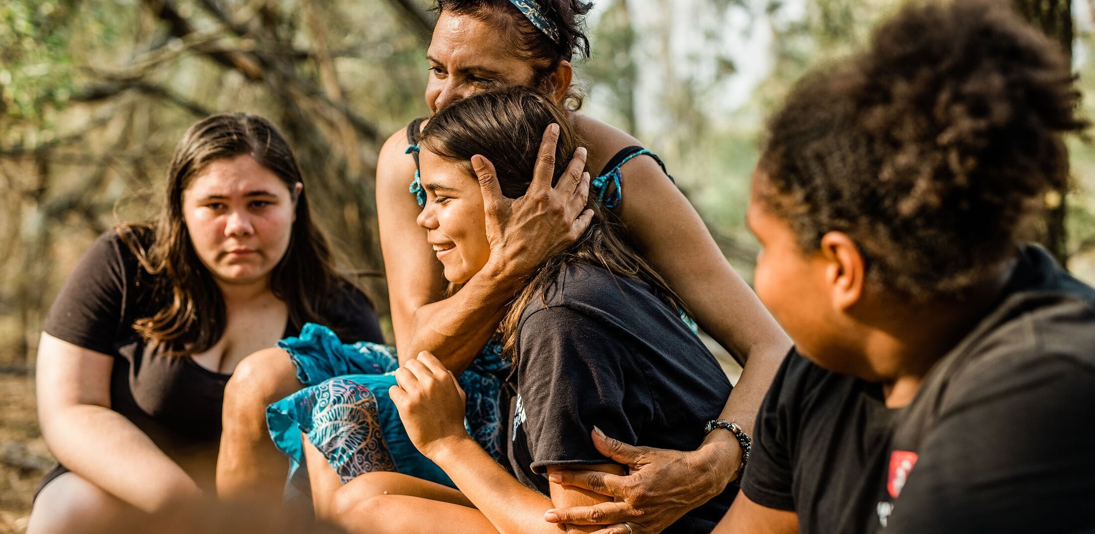 Two people embrace during a Desert Pea Media project in Maclean