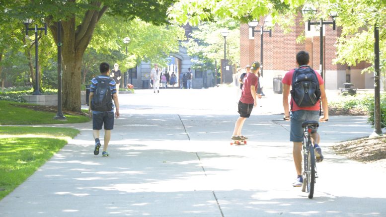 People walking and riding on campus