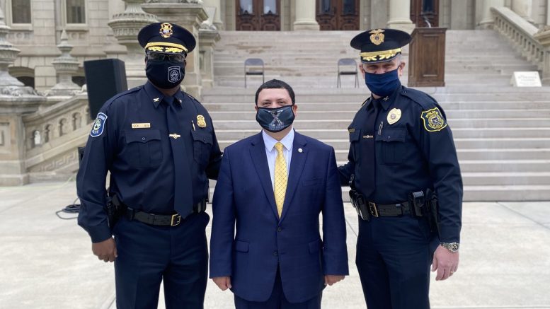 Ann Arbor Police Chief Michael Cox, Xavier DeGroat and U-M Police Chief Robert Neumann pose for a photo at the capitol.