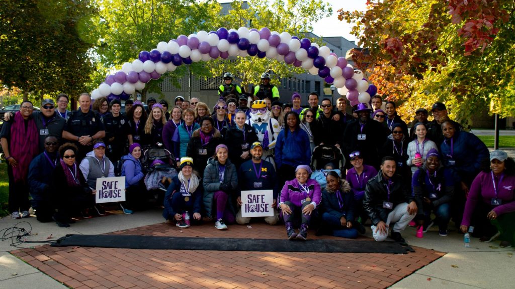Participants and organizers at the 2018 Purple Run organized by SafeHouse Center, the Washtenaw County Prosecutor's Office, and DPSS.