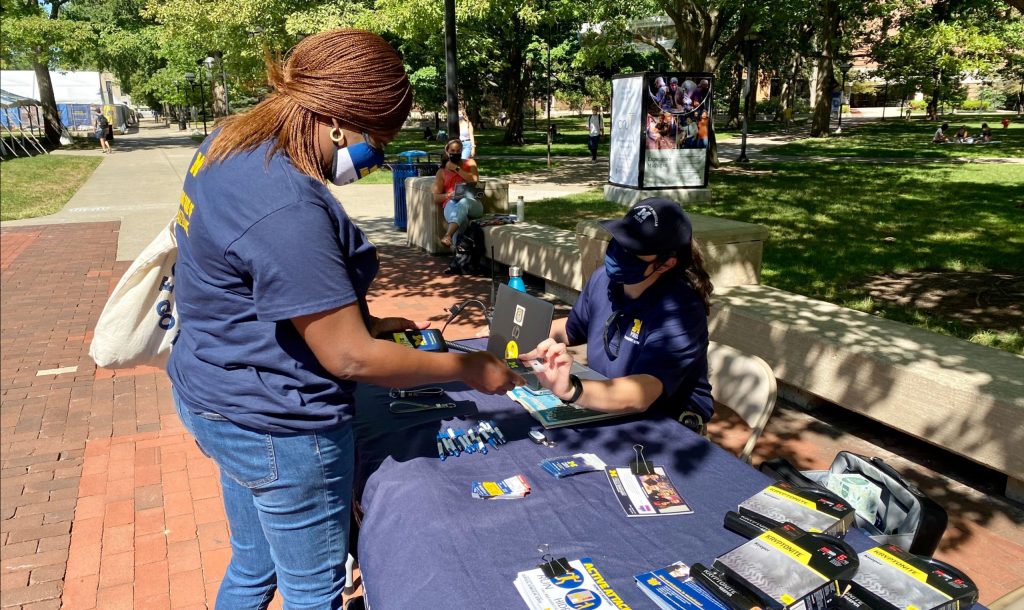 DPSS officer on the Diag registering personal electronics and bikes to help prevent theft.