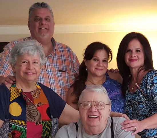 Celia posing for a group photo with her parents and two of her siblings