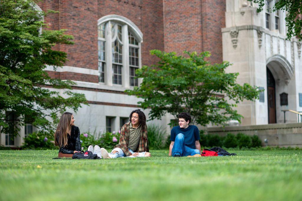 Students sitting on the grass on University of Michigan campus