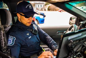 Sgt. John-Mark Branch works on his in car computer during a traffic stop.