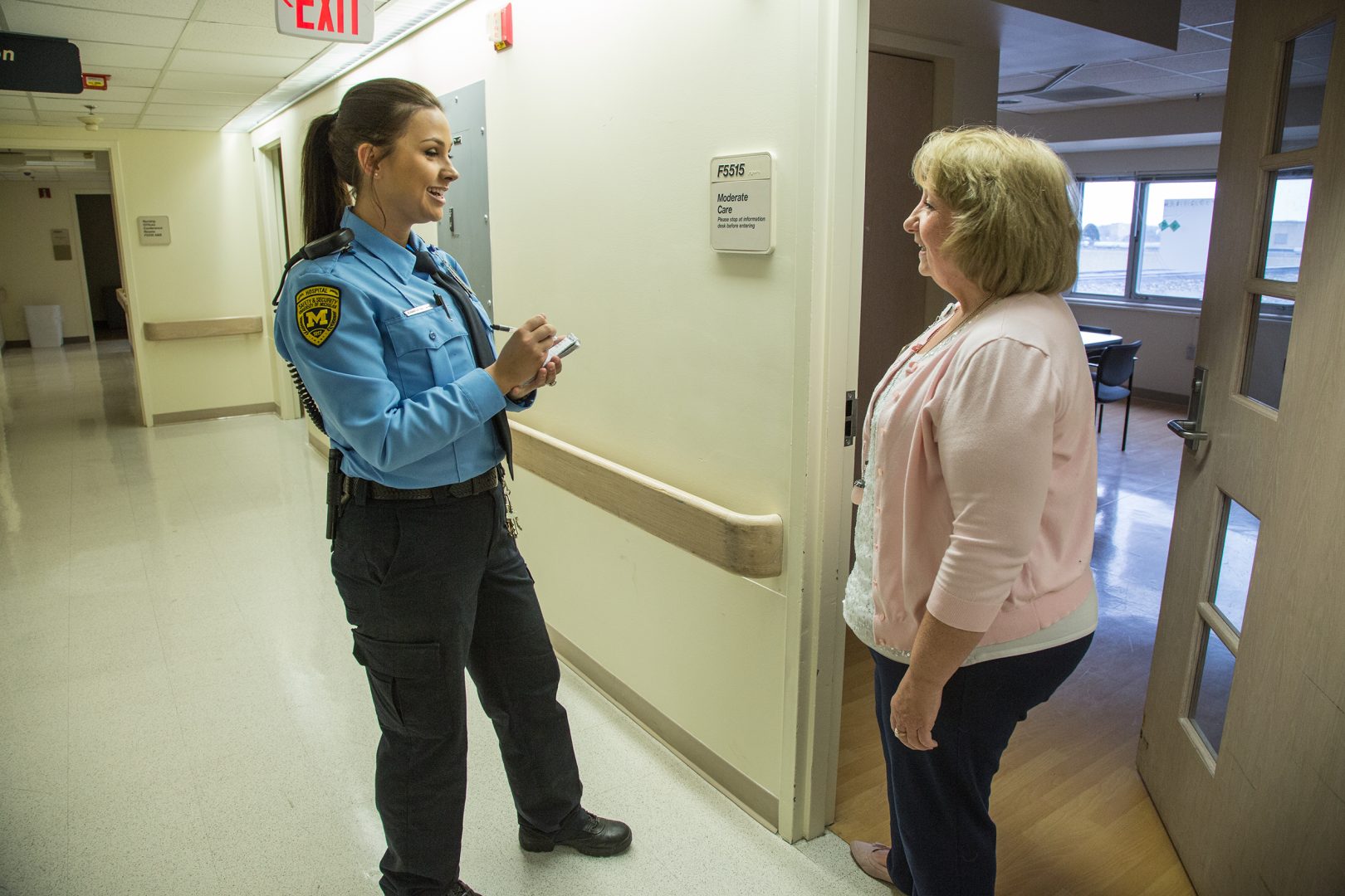 Security Officer takes information from a Michigan Medicine Staff member.