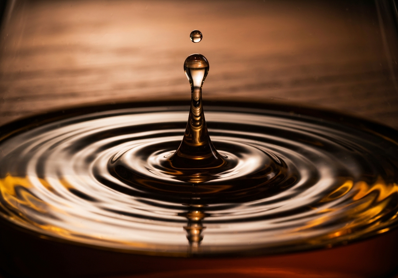A macro shot of a single drop of water hitting the surface of a dark amber whisky, showing the 'viscous swirls' (marangoni effect).