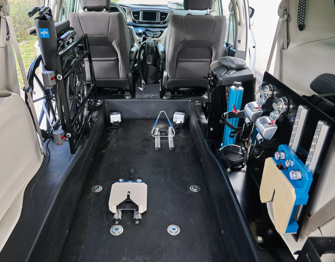 The interior of a BraunAbility rear entry NEMT Chrysler minivan.