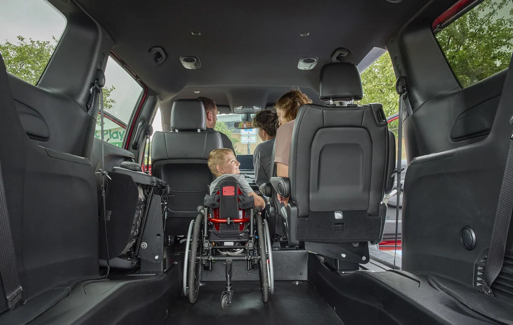 Child in a wheelchair riding inside a BraunAbility Chrysler Voyager