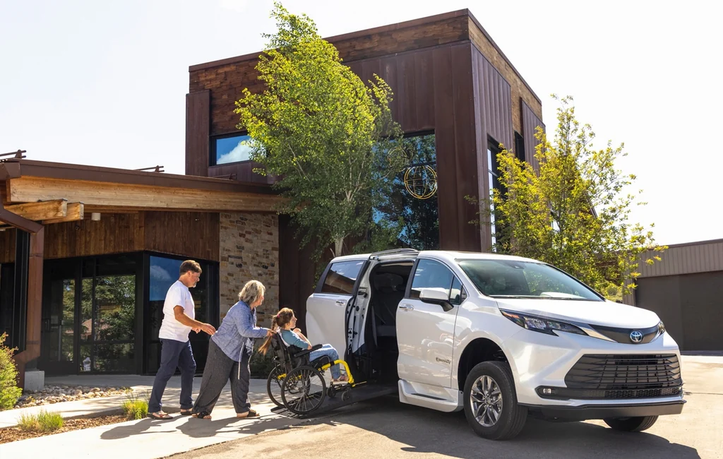 Family loading a wheelchair into a BraunAbility Toyota Sienna