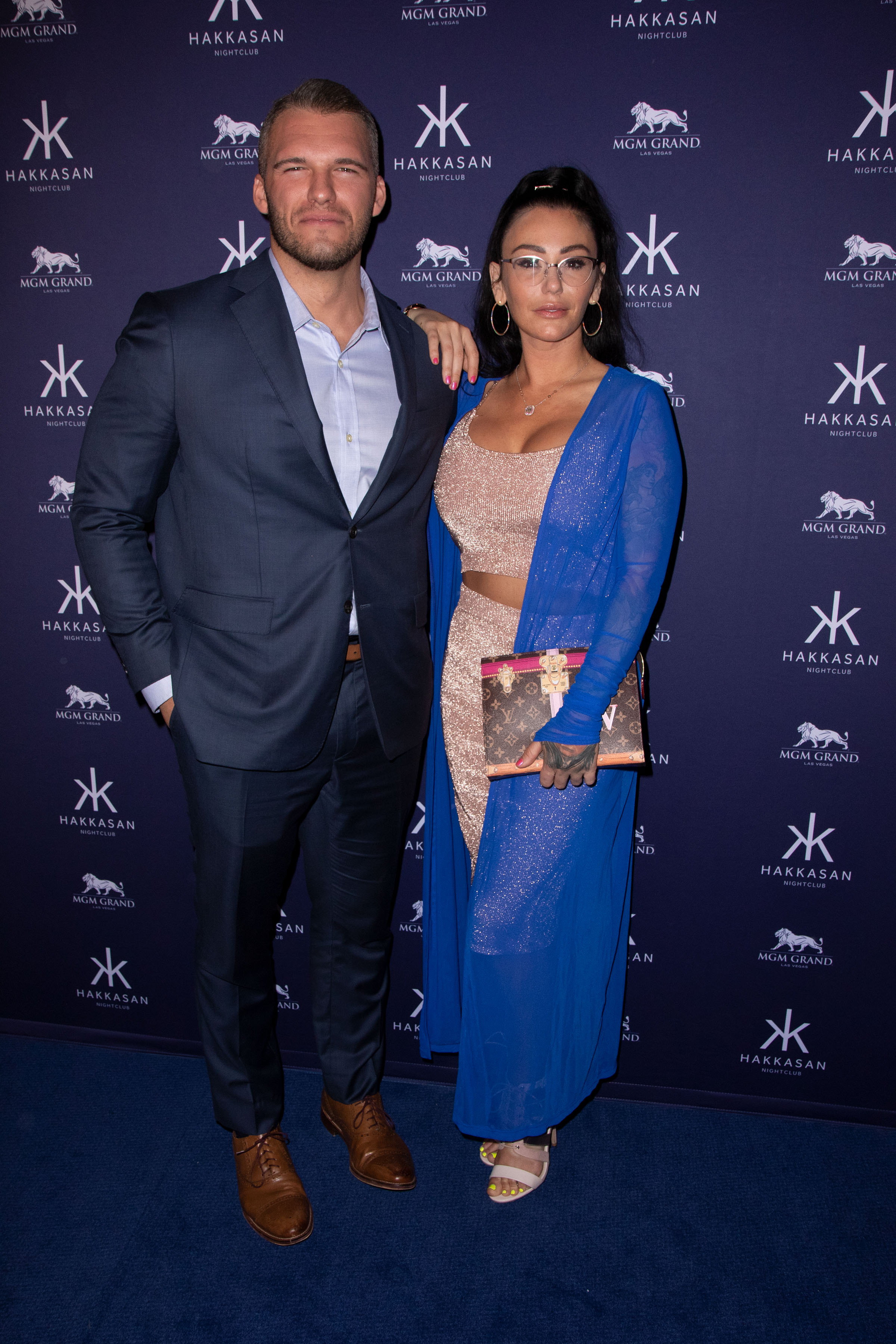 A photo showing Jenni JWoww Farley and pro-wrestler, Zack Carpinello at a blue-carpet event and they look stylish and beautiful.