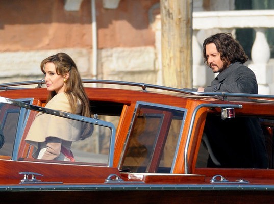 A photo showing Angelina Jolie and Johnny Depp entering into a vehicle from different side doors.