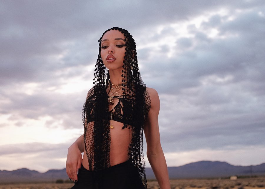 FKA Twigs looks adorable in this black brallette and pants, with a beautiful scarf on her head.