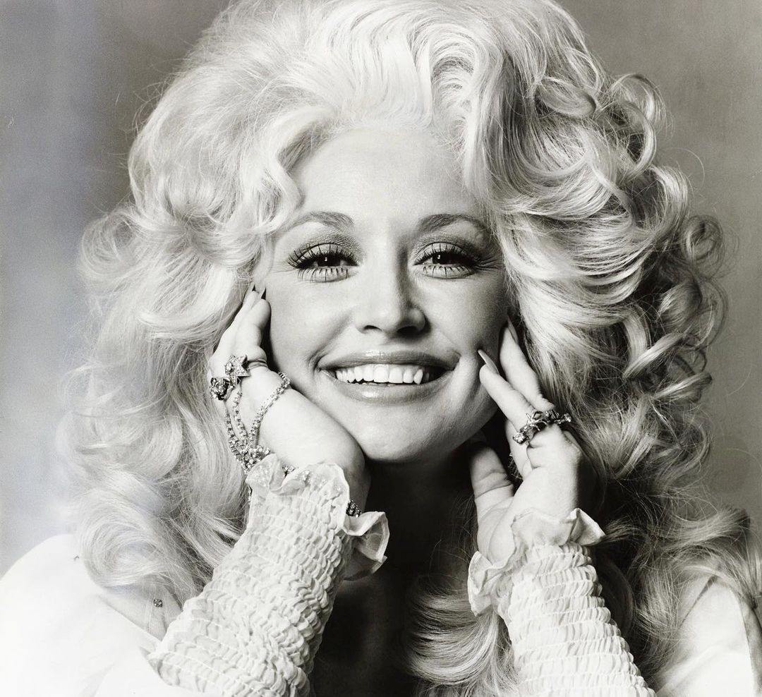 A throwback picture of Dolly Parton smiling beautifully at the camera.
