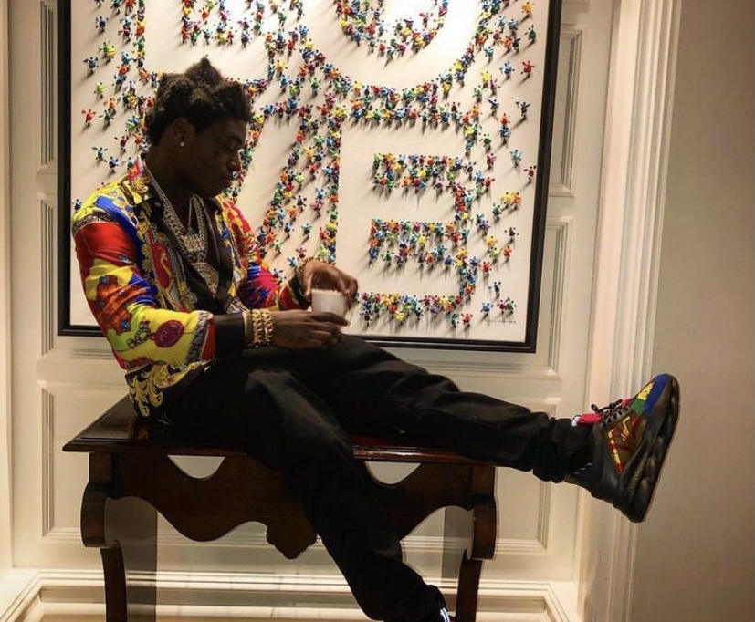 Kodak showing off one of his outfits.