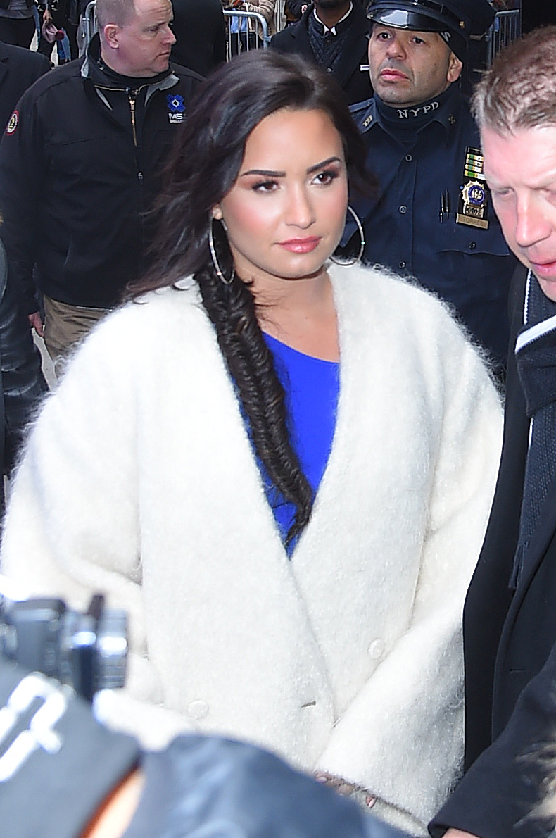 A photo showing Demi Lovato making an appearance at the GMA, wearing a white outfit. 