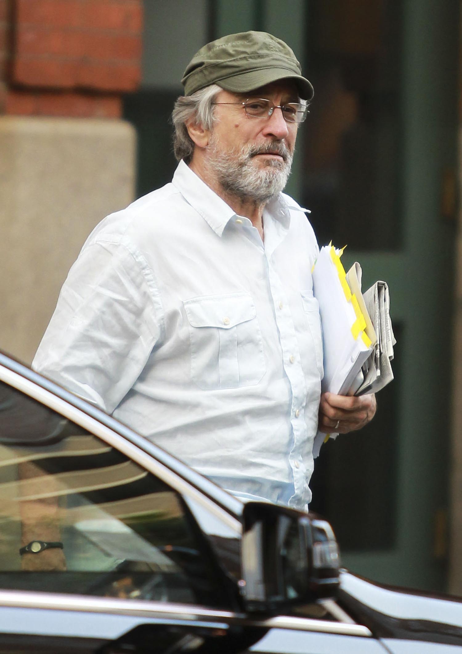 A throwback photo f Robert De Niro spotted on the streets in a casual outfit, carrying some files and a newspaper.