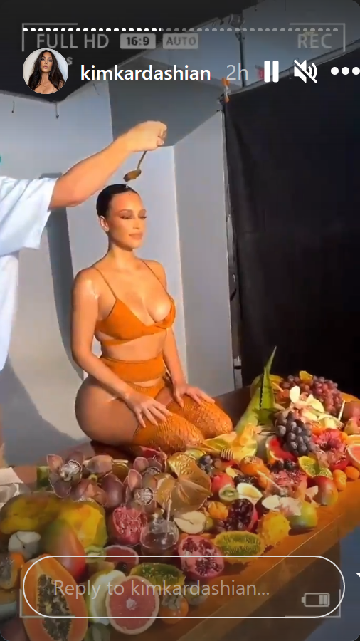 Kim Kardashian with honey being put on face