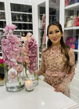 Dr. Tiffany Moon poses with flowers in her closet.