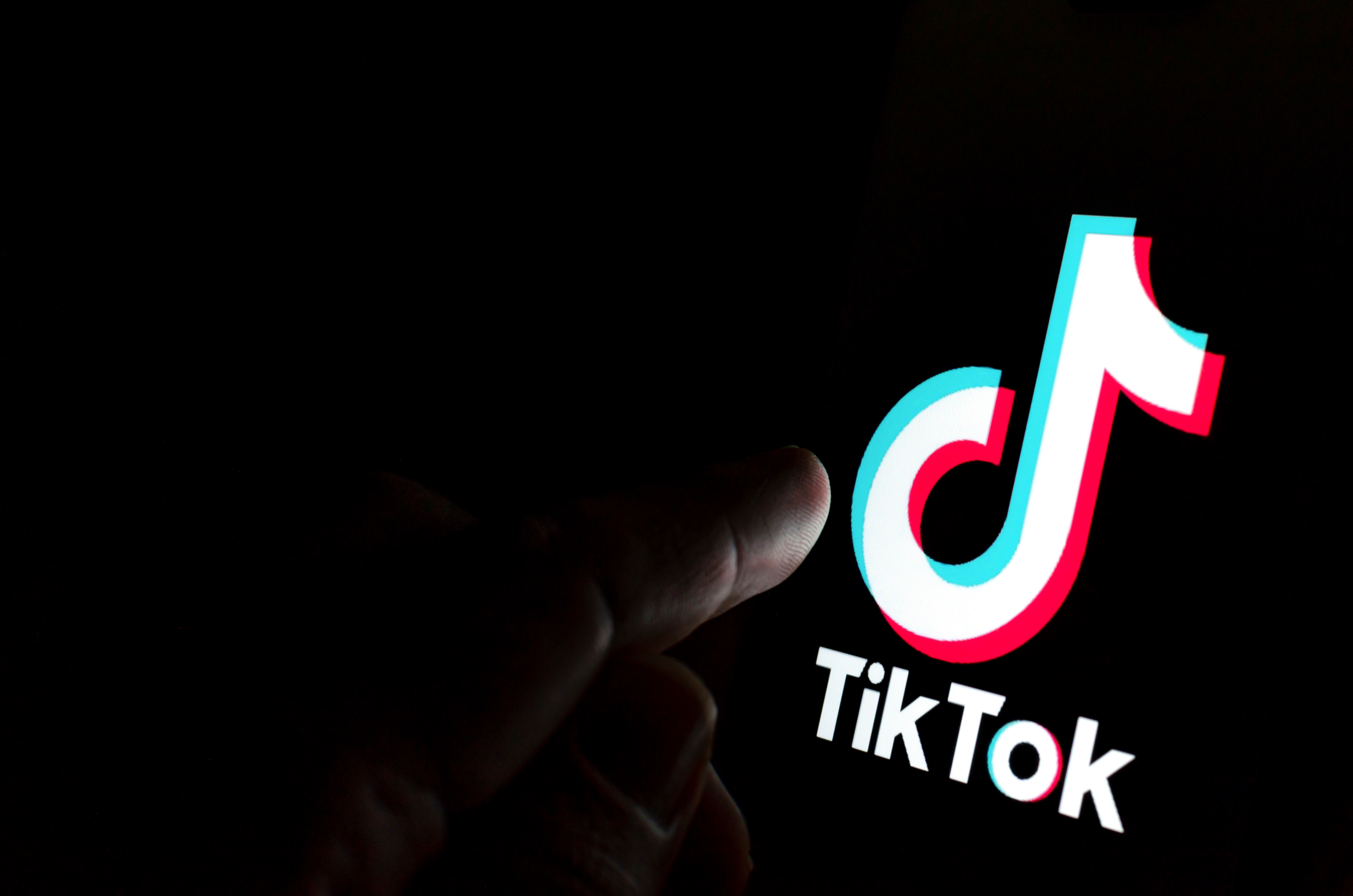 A photo showing the TikTok application sign glowing int he dark.