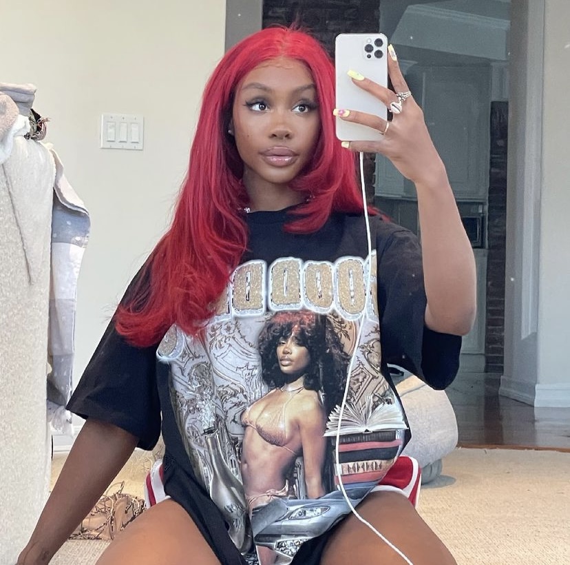 SZA showing off her customized t-shirt of herself.