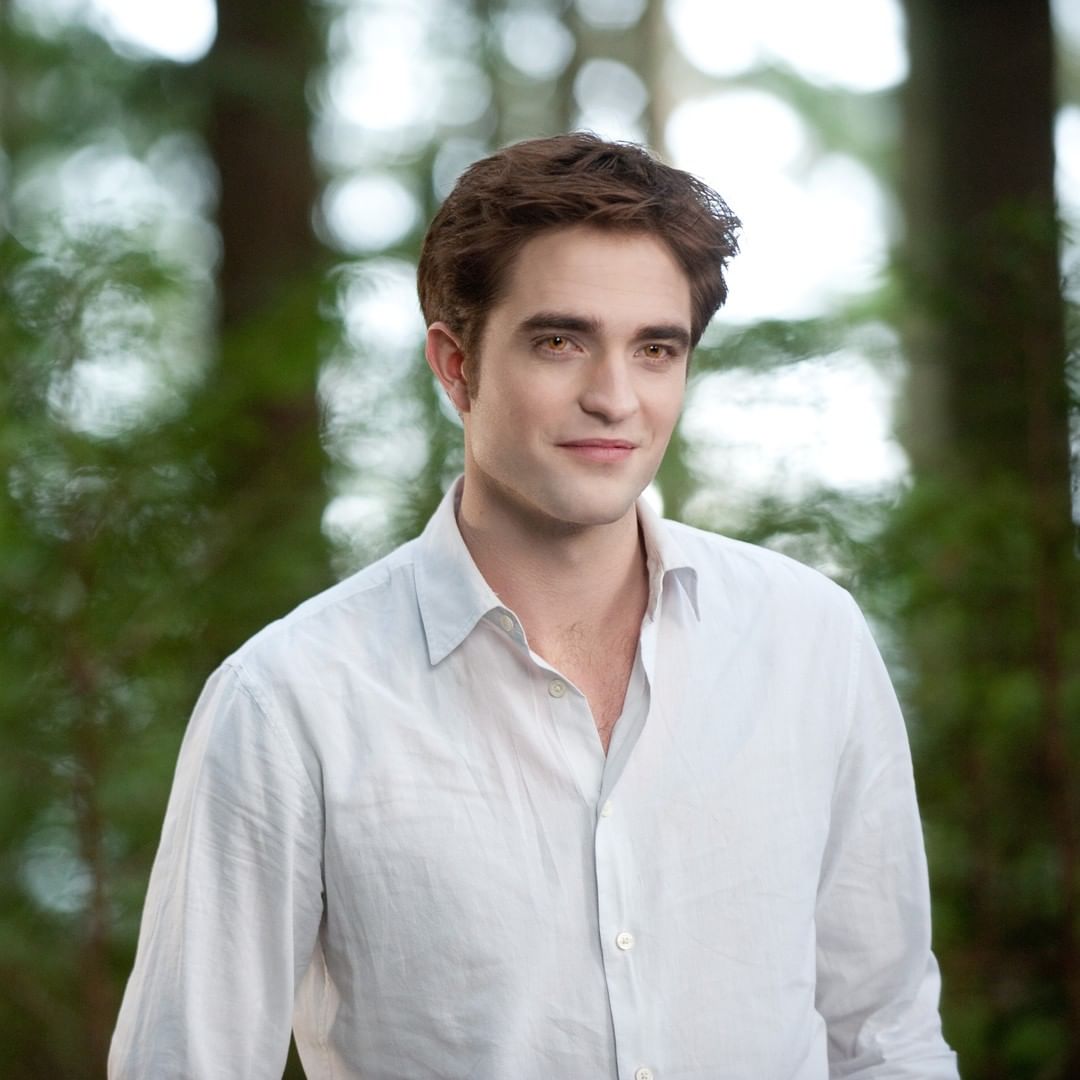 A beautiful photo Robert Pattinson in a plain white T-shirt with glowy eyes.