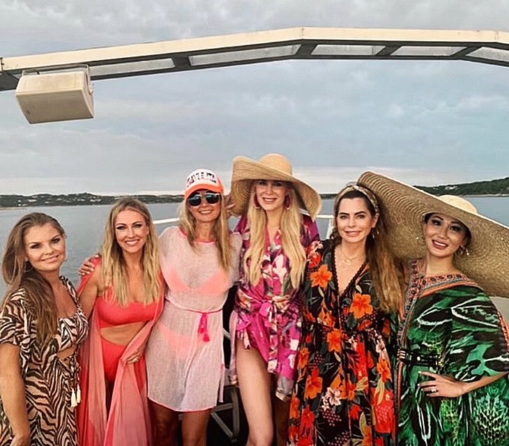 Stephanie Hollman and the 'RHOD' cast wear hats and swim attire on the water.