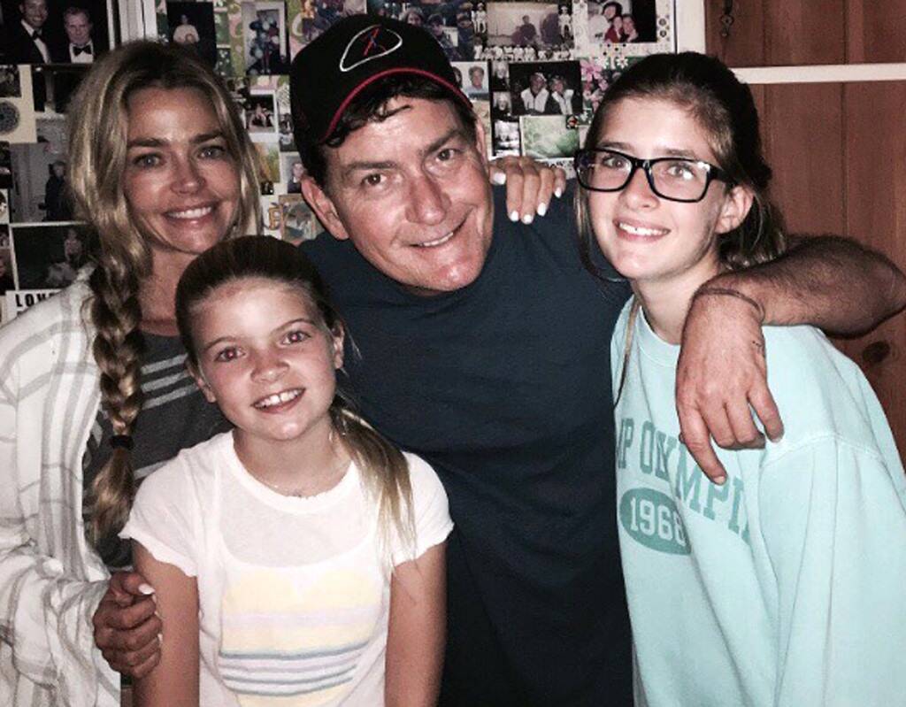 Charlie Sheen smiles with daughters Lola and Sam and ex-wife Denise Richards.