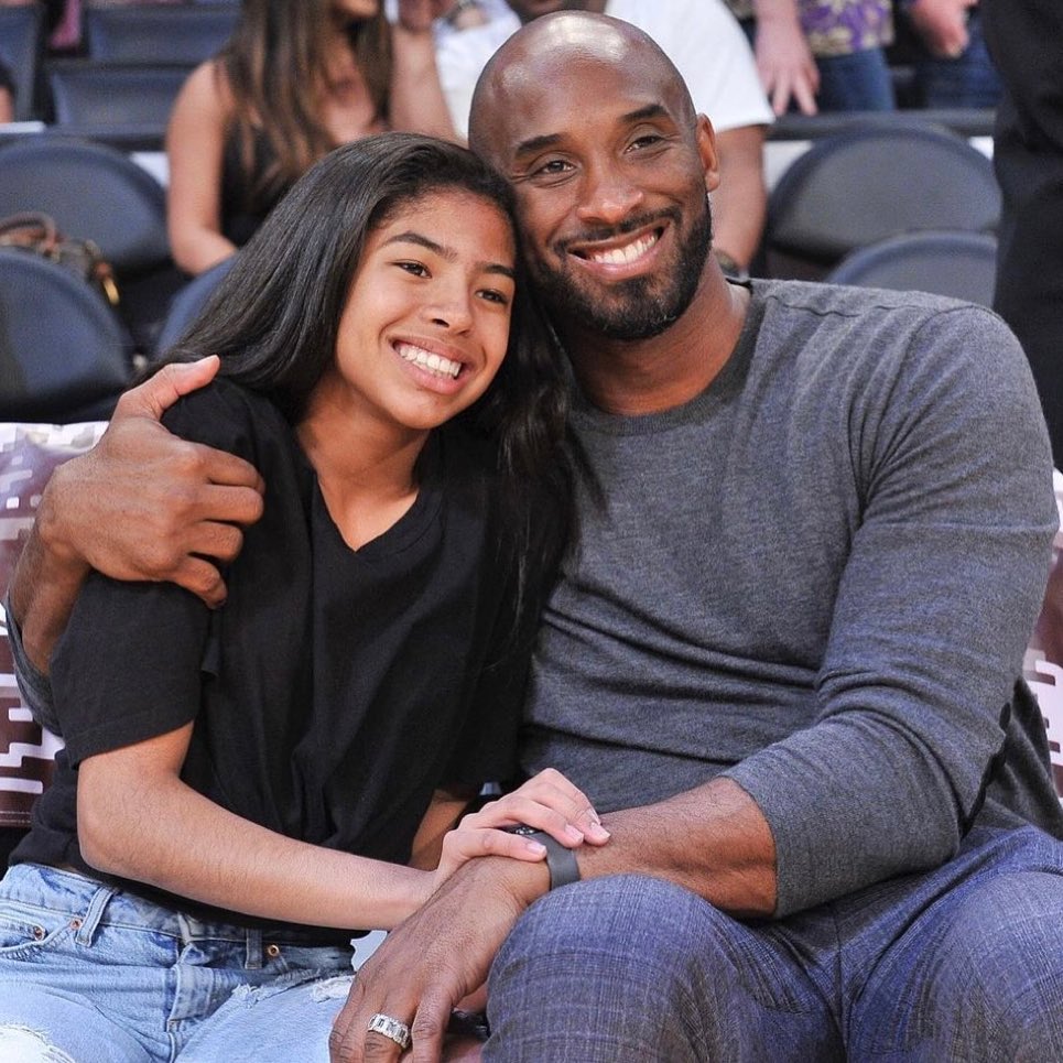 An iconic photo of Mamba & Mambacita smiling at a game as they spend father-daughter time.