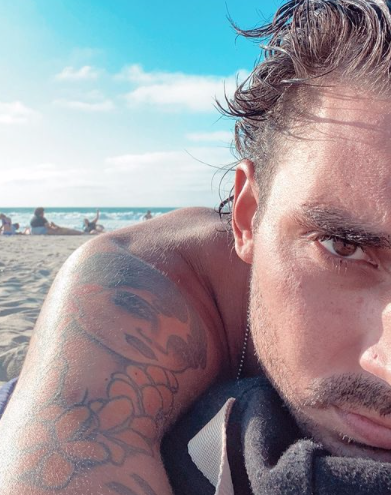 Max Boyens shows off his tattoos at the beach.