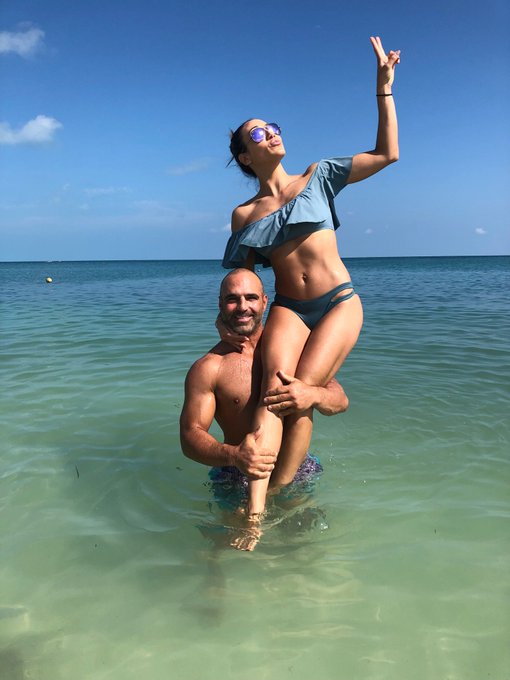 Joe Gorga holds Melissa Gorga in the water.