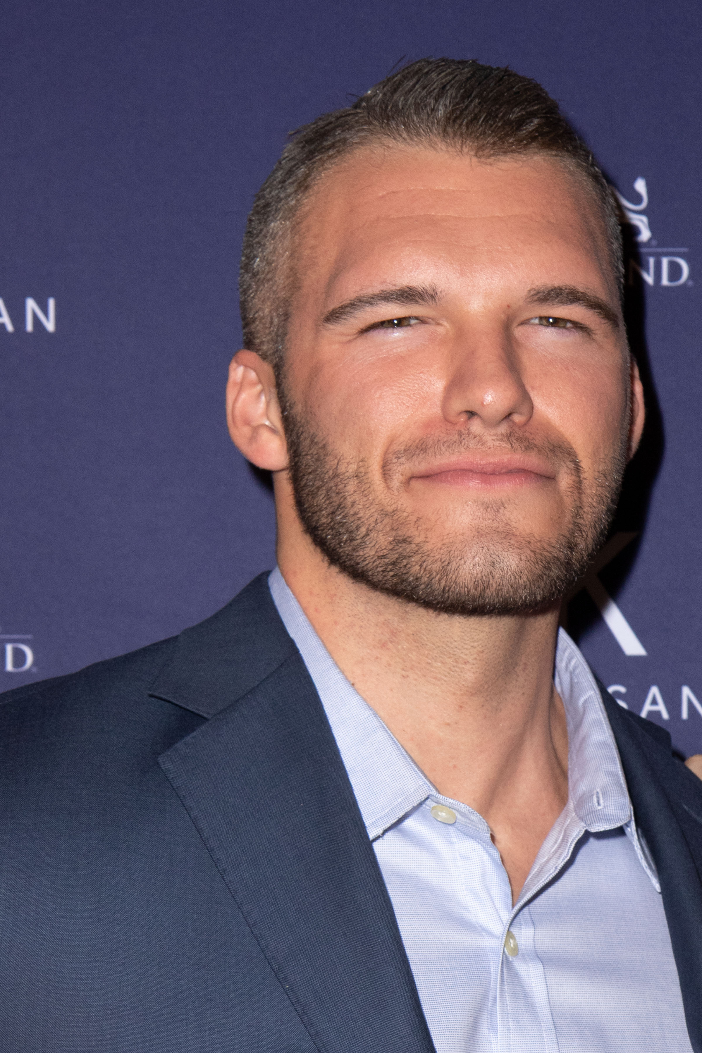 Zack Carpinello looks incredible in this blue suit and inner T-shirt at an event.