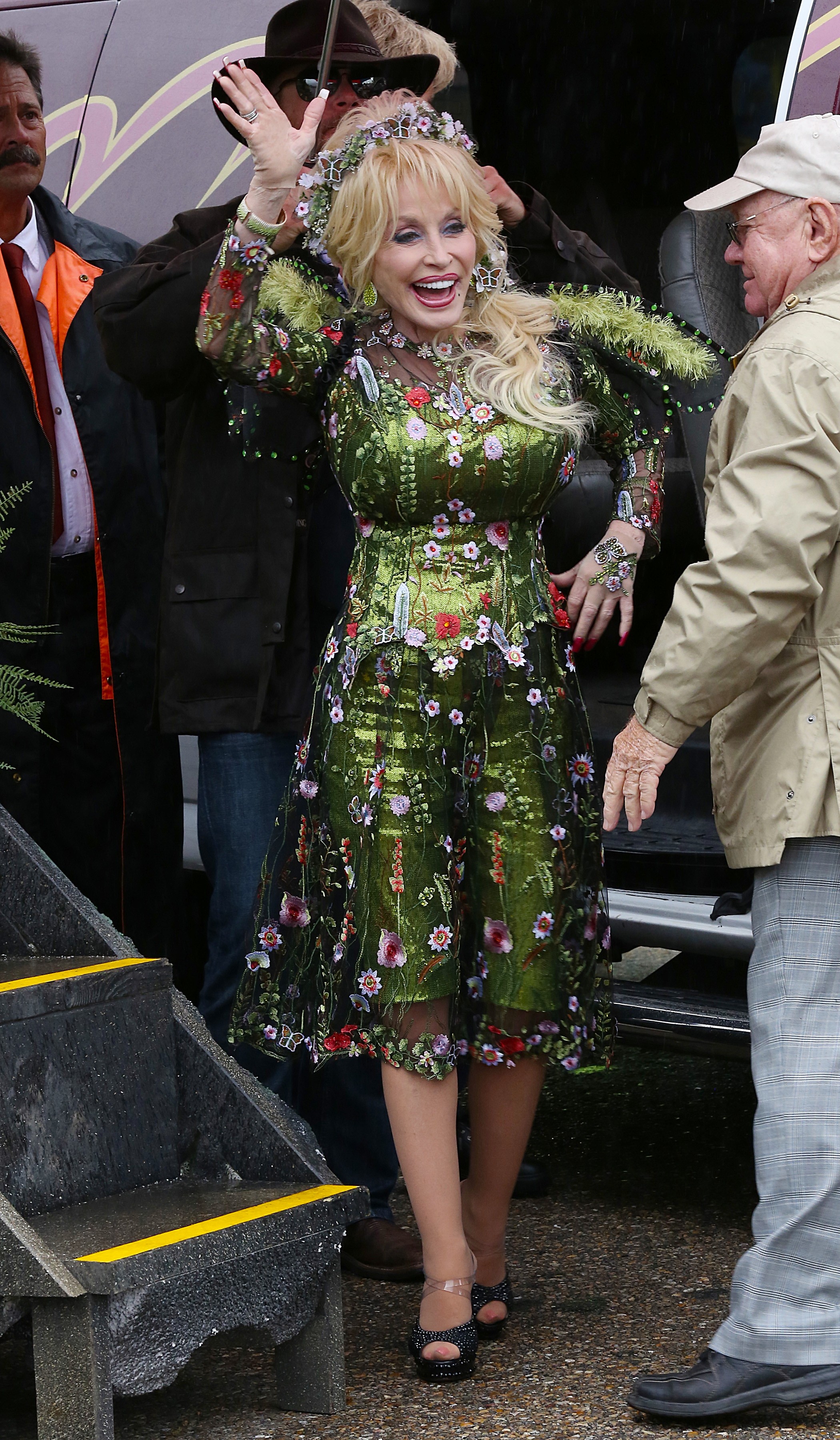 A photo showing Dolly Parton in a green fowery dress, at the 32nd Annual Dolly Homecoming Parade in Pigeon Forge, Tennessee.