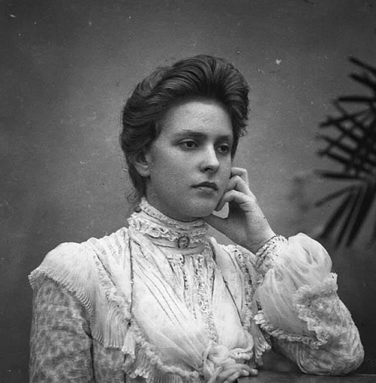 A photo showing a young Princess Alice of Battenberg in a white turtleneck dress.