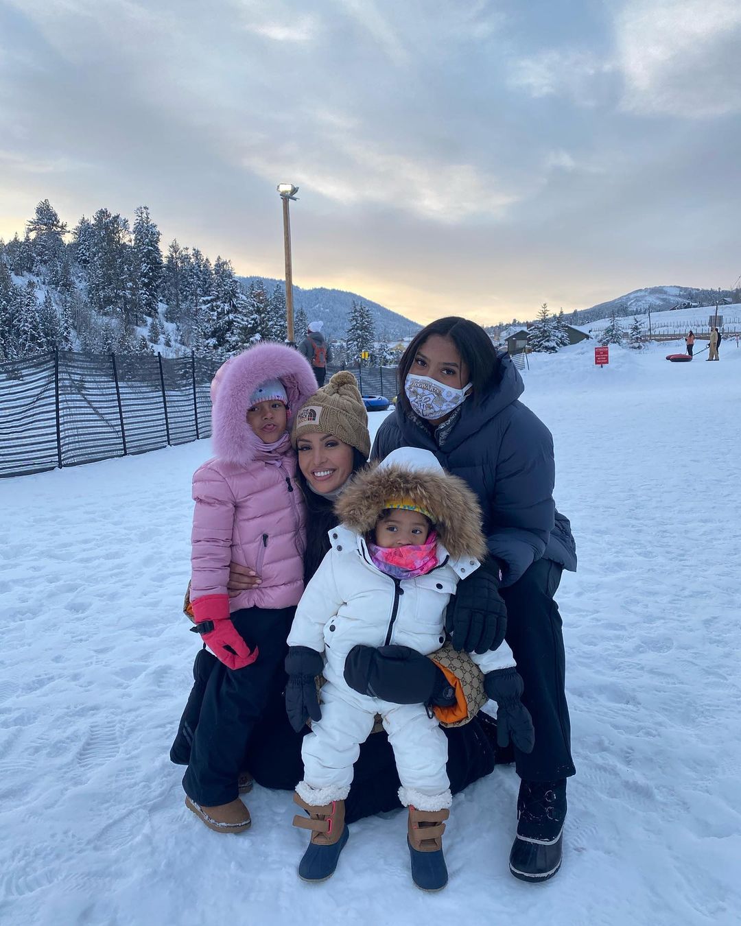 A photo showing The Bryant family spending time on an ice-filled area and they are all in beautiful fur coats.