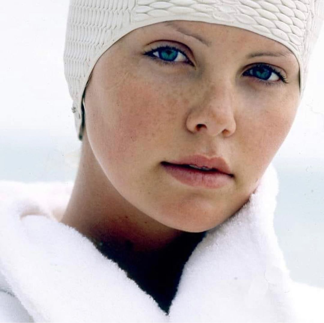 A lovely photo showing Charlize Theron rocking a white robe and swim cap and she looks gorgeous.