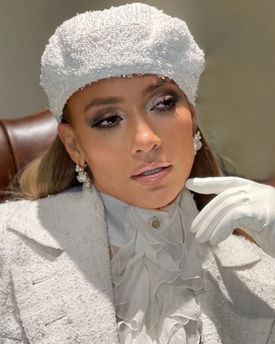 Jennifer Lopez looks amazing in this stylish white apparel with a matching hat and gloves.