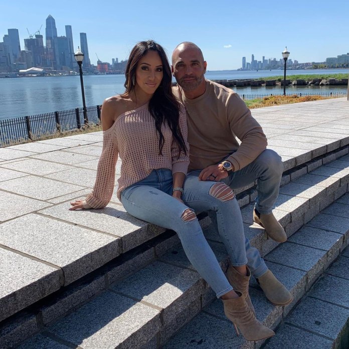 Melissa Gorga wears a pink sweater with Joe Gorga in beige.