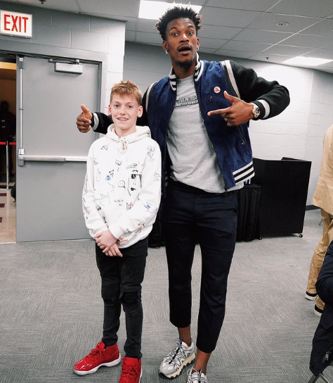 Jimmy Butler poses with a young fan.