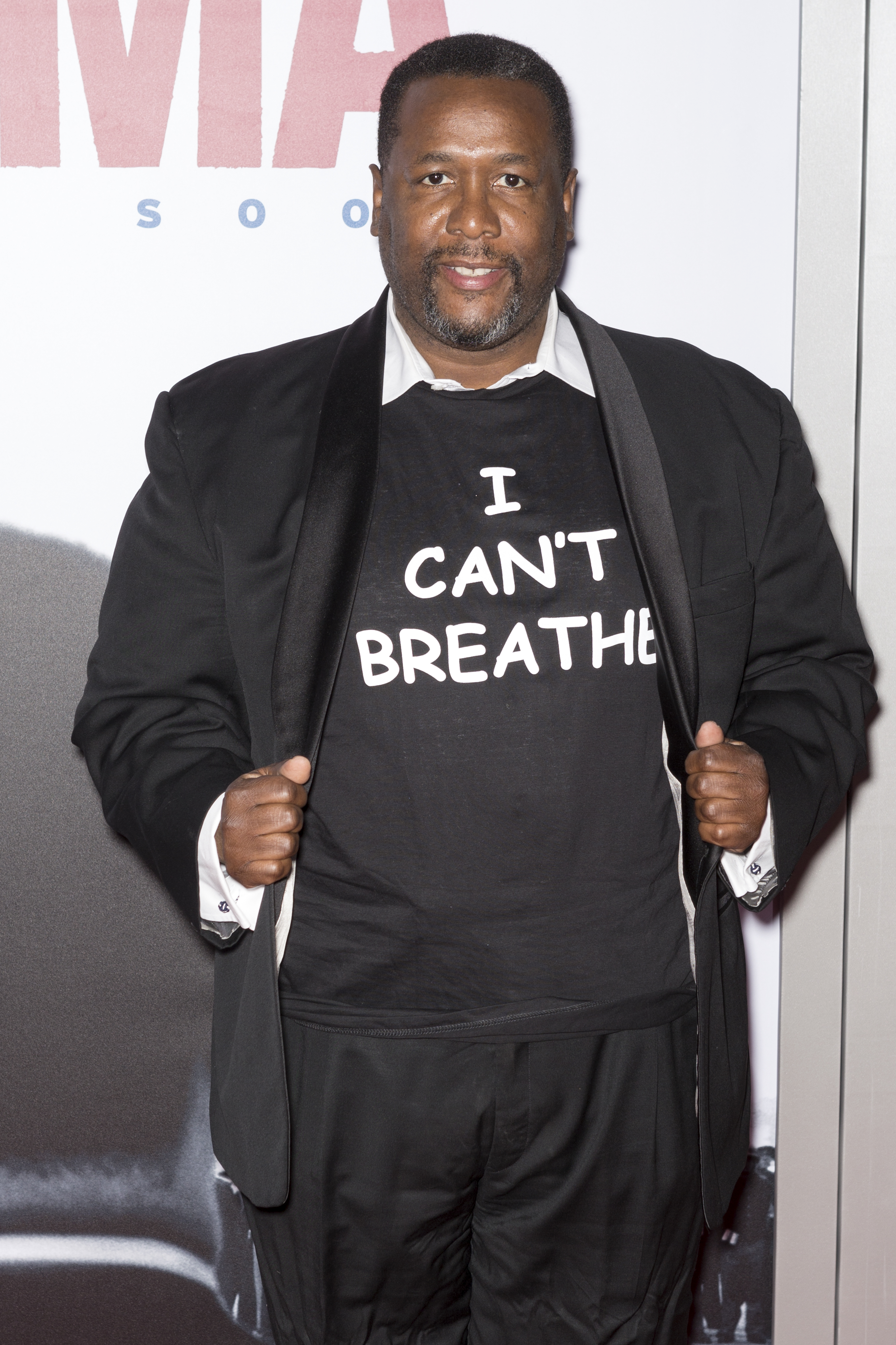 A photo showing Wendell Pierce in all-black outfits and his shirt has a bold inscription on it saying 'I can't breathe.'