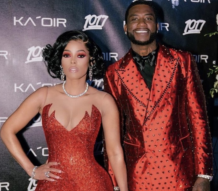 Keyshia and Gucci sporting matching red outfits at an event.