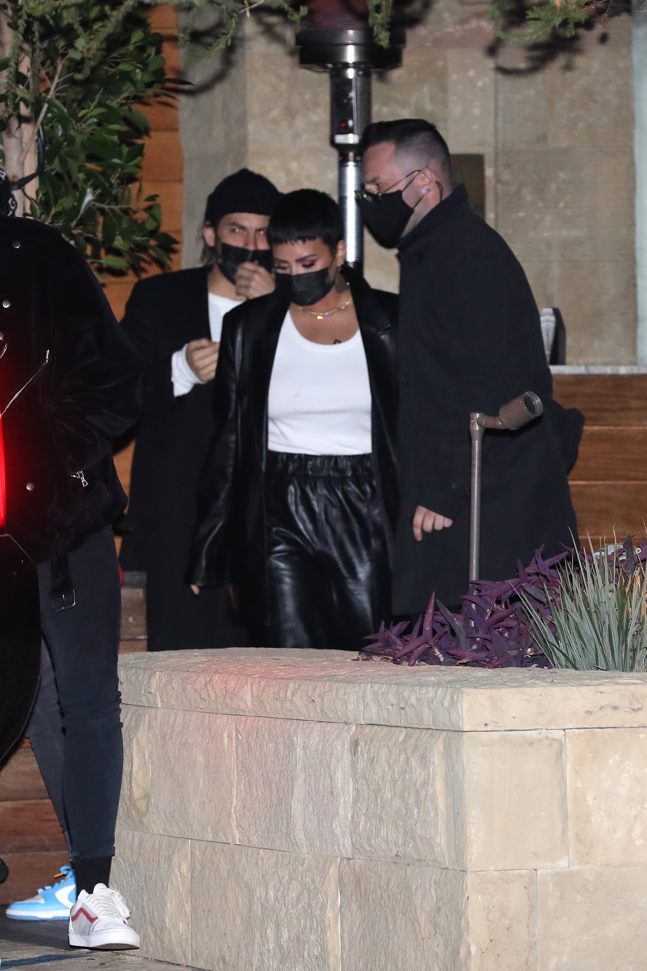 Demi Lovato spotted leaving a location in a black leather jacket and pant with a white inner blouse.