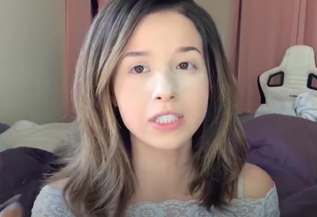 Pokimane sitting on bed with no makeup. 