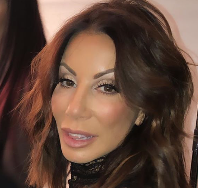 Danielle Staub wears makeup and short hear.